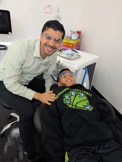 Dr. Ron performing teeth whitening on a teenage boy in San Ramon, CA